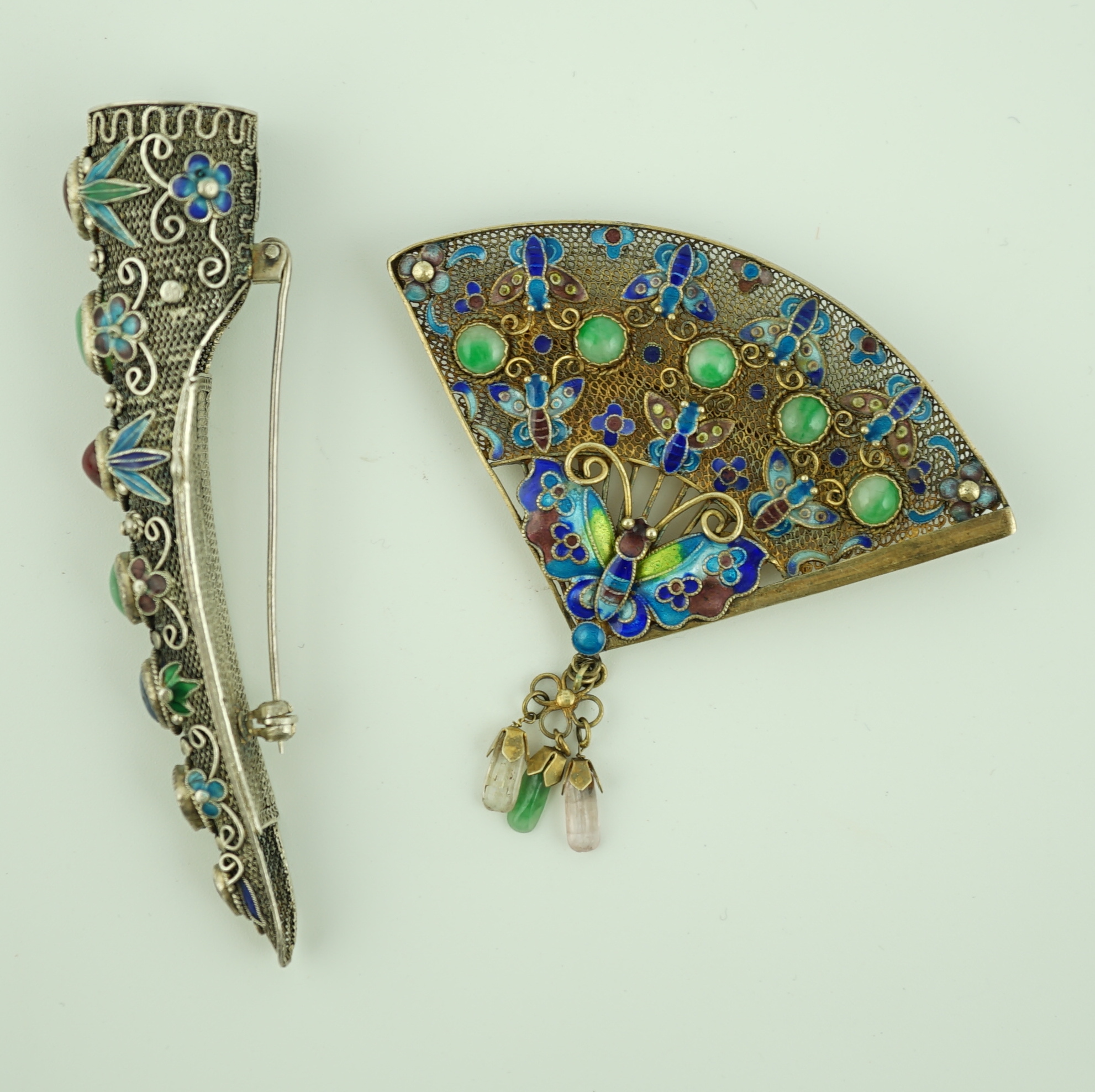 A Chinese silver, enamel and jadeite 'fan' brooch, width 69mm and a similar nail guard brooch, 87mm